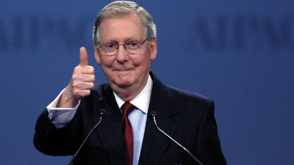 Kentucky Senator Mitch McConnell with an asshole grin giving a thumbs-up.